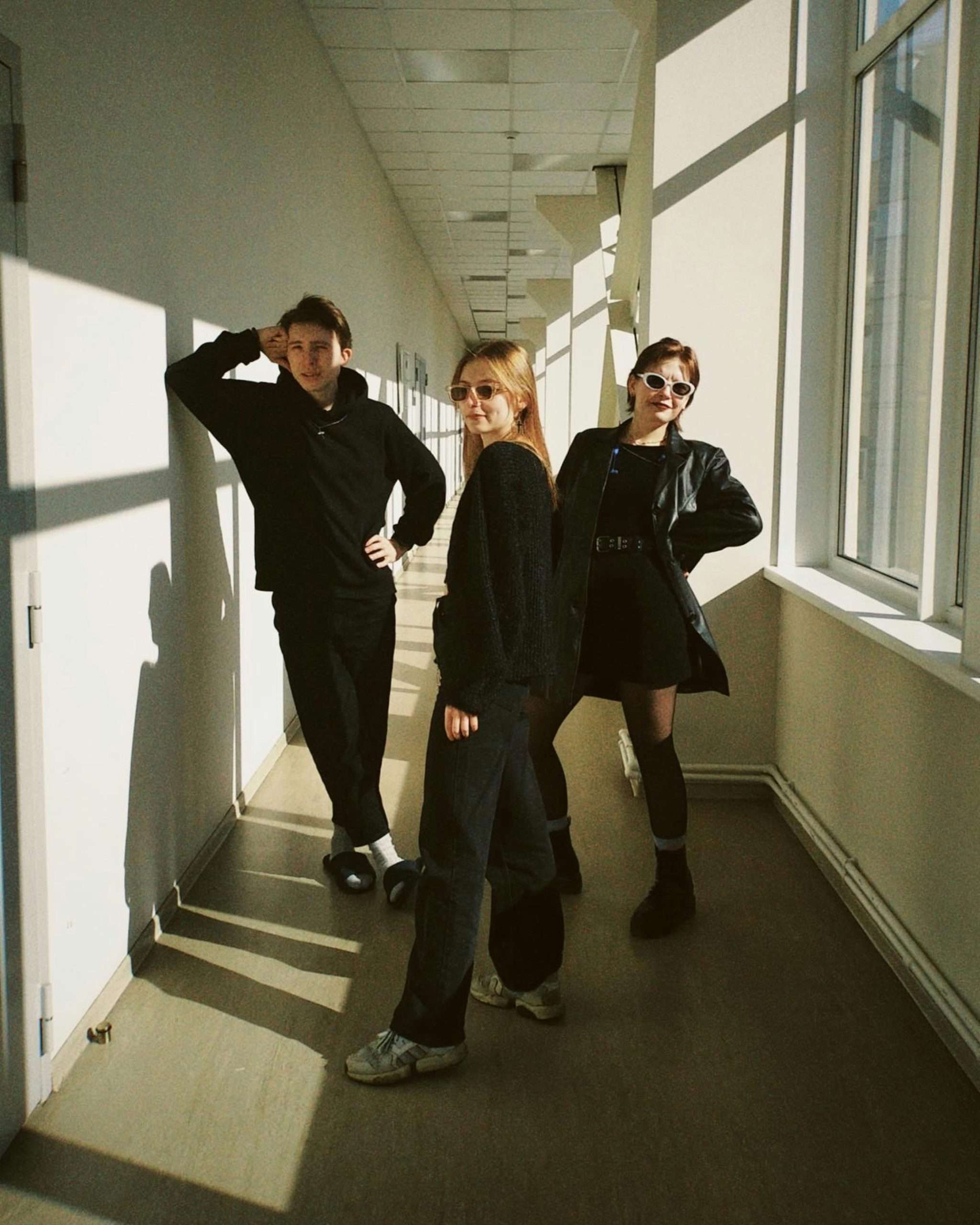 people posing in black outfits