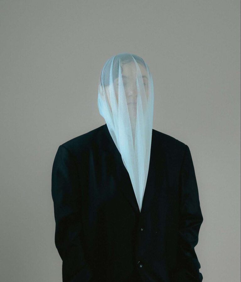 girl wearing a black and white outfit with a microfiber cloth tapping her head