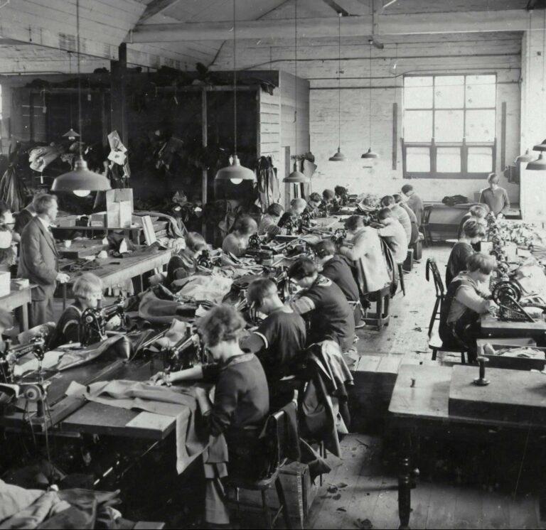 historic photo from a production site with women making clothes