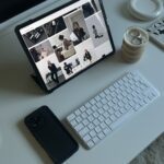 Desk with tablet and phone analysing fashion market.