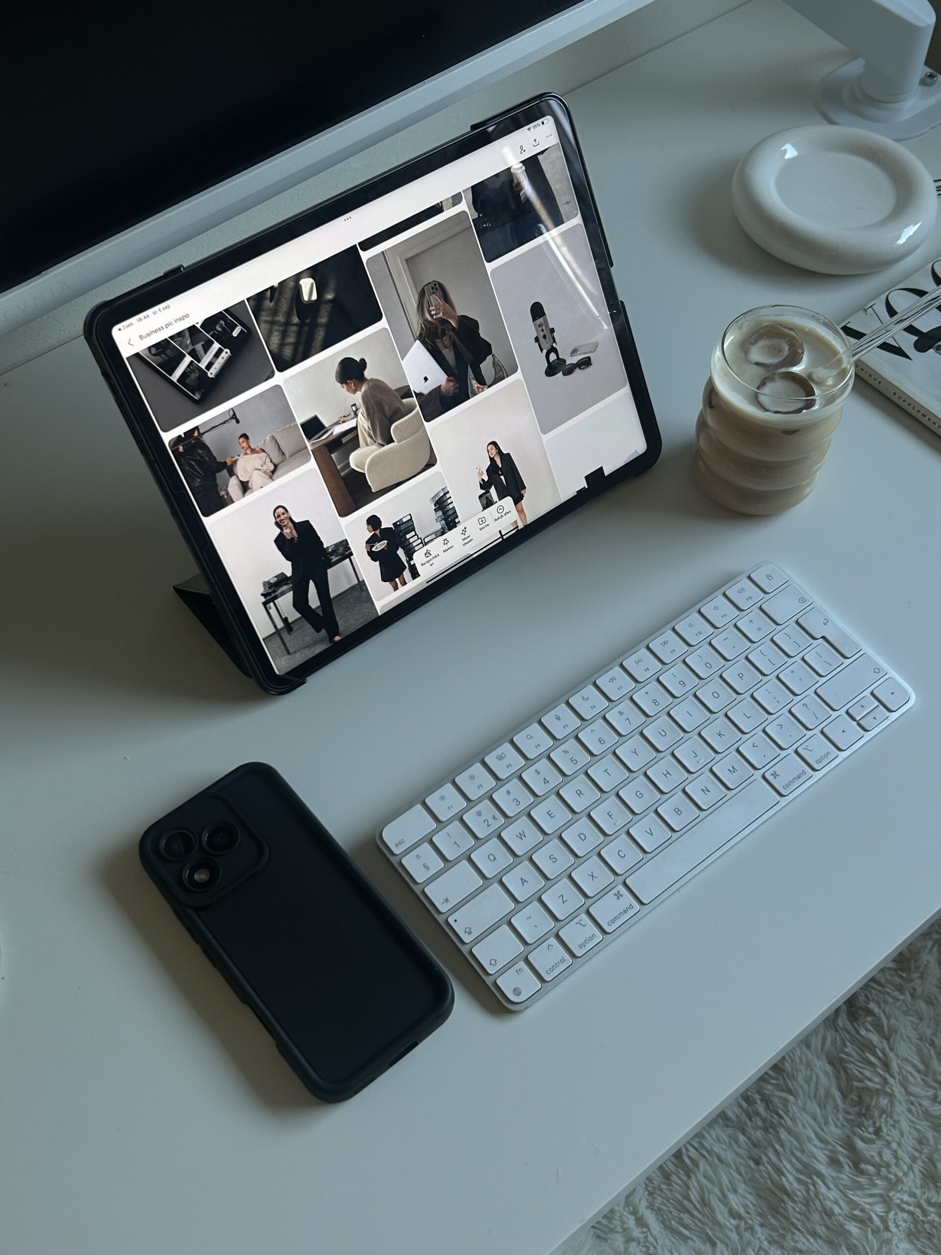 Desk with tablet and phone analysing fashion market.